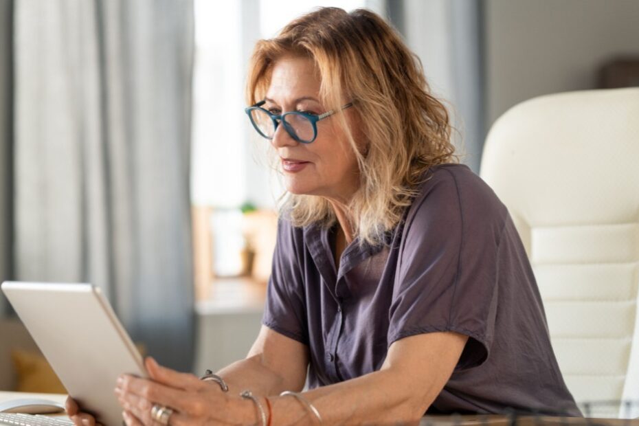 Woman holding a tablet to Know About Changes to Superannuation Tax Concessions and Their Impact on Estate Planning